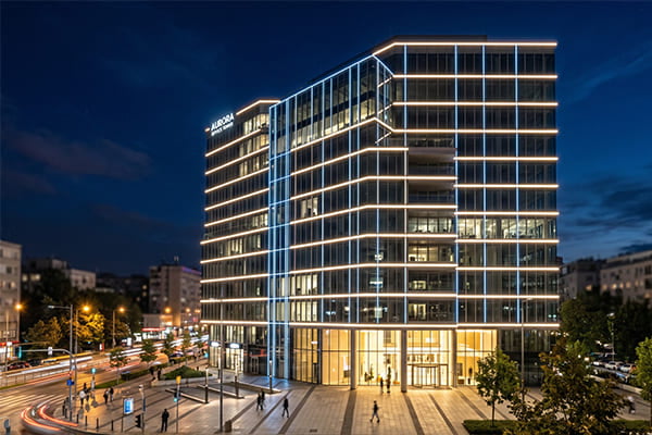An office building facade illuminated with modern linear LED lights at night